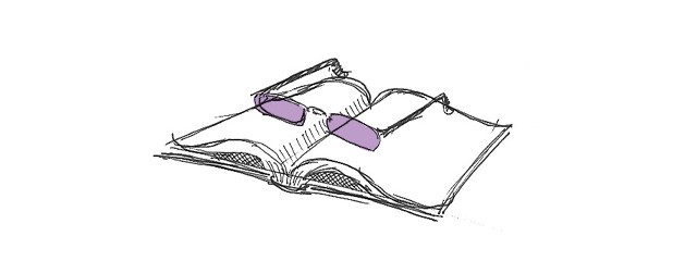 A pair of reading glasses resting on an open book